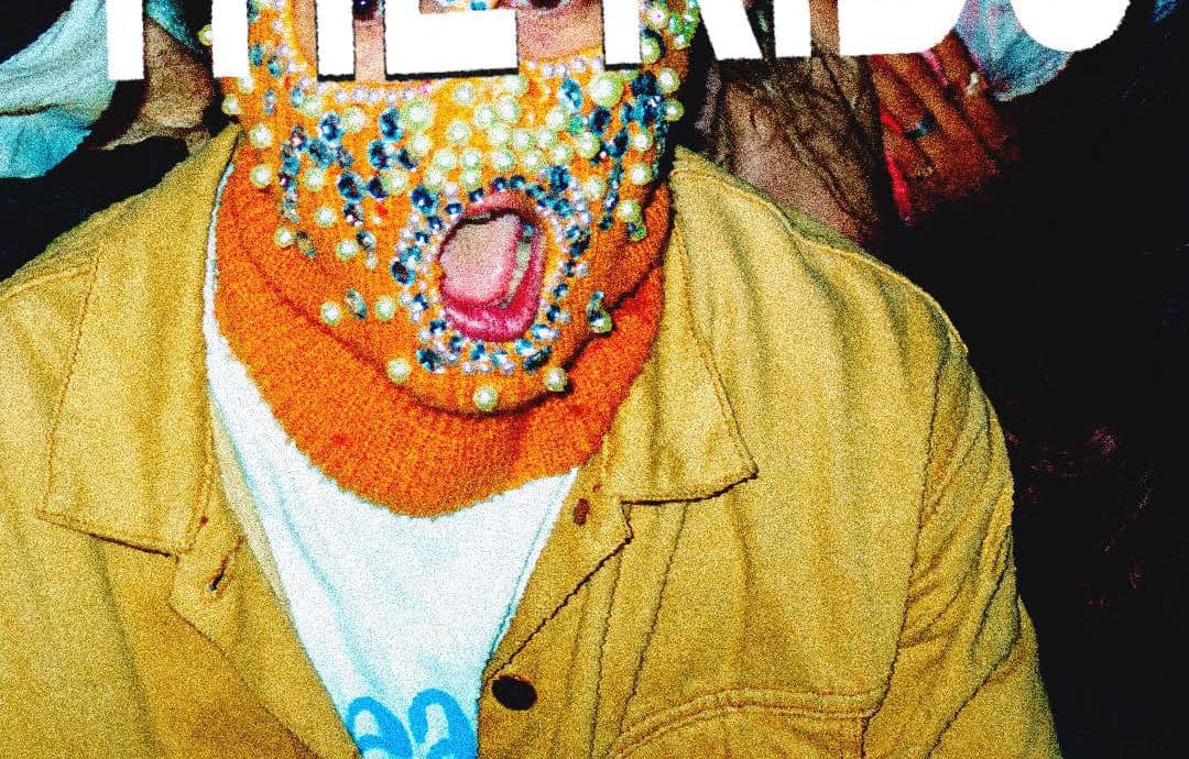Kid in a beaded ski mask at a show